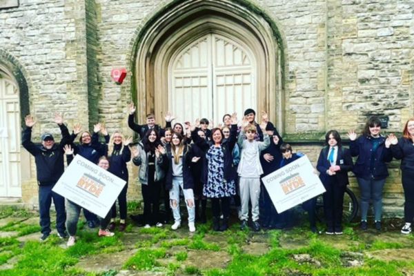 Young people waving and cheering outside the new home for the youth service, Network Ryde on the Isle of Wight